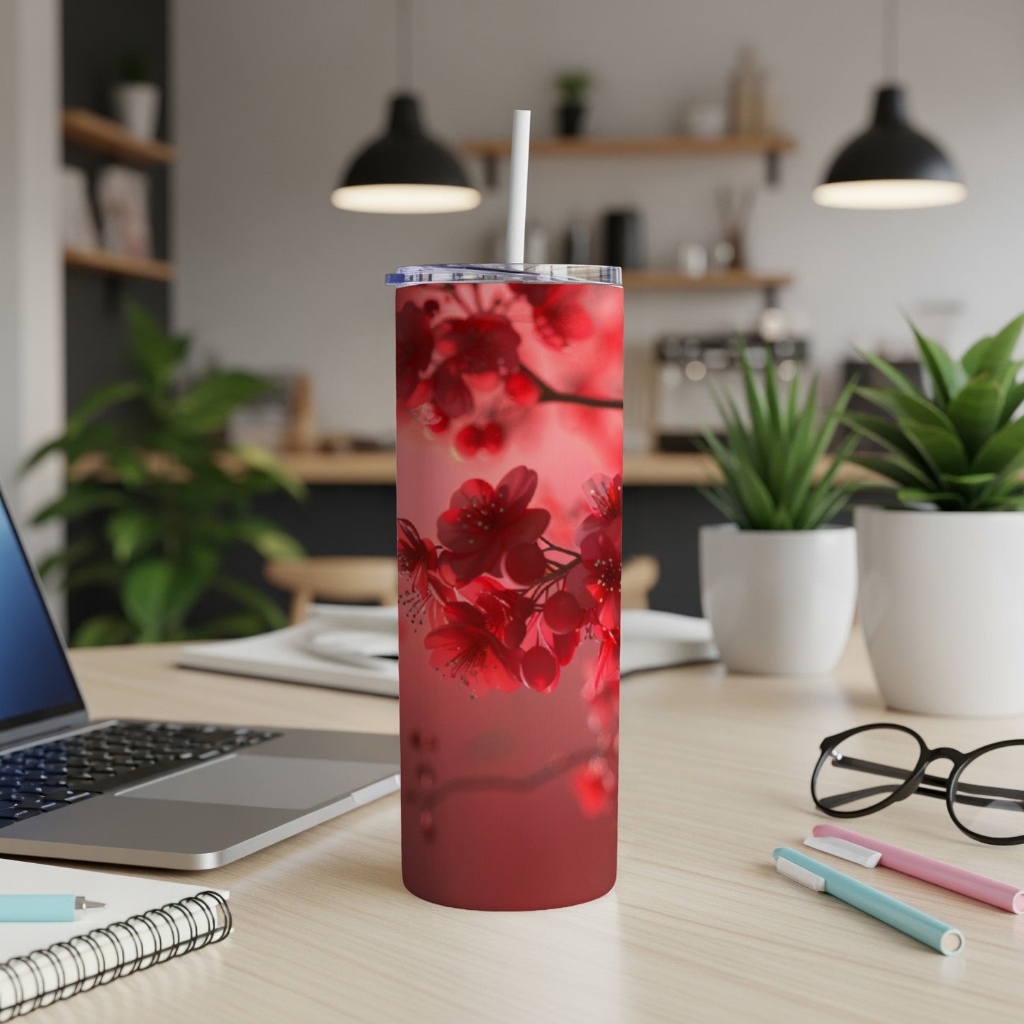 Red cherry blossoms on a tumbler with a white straw.
