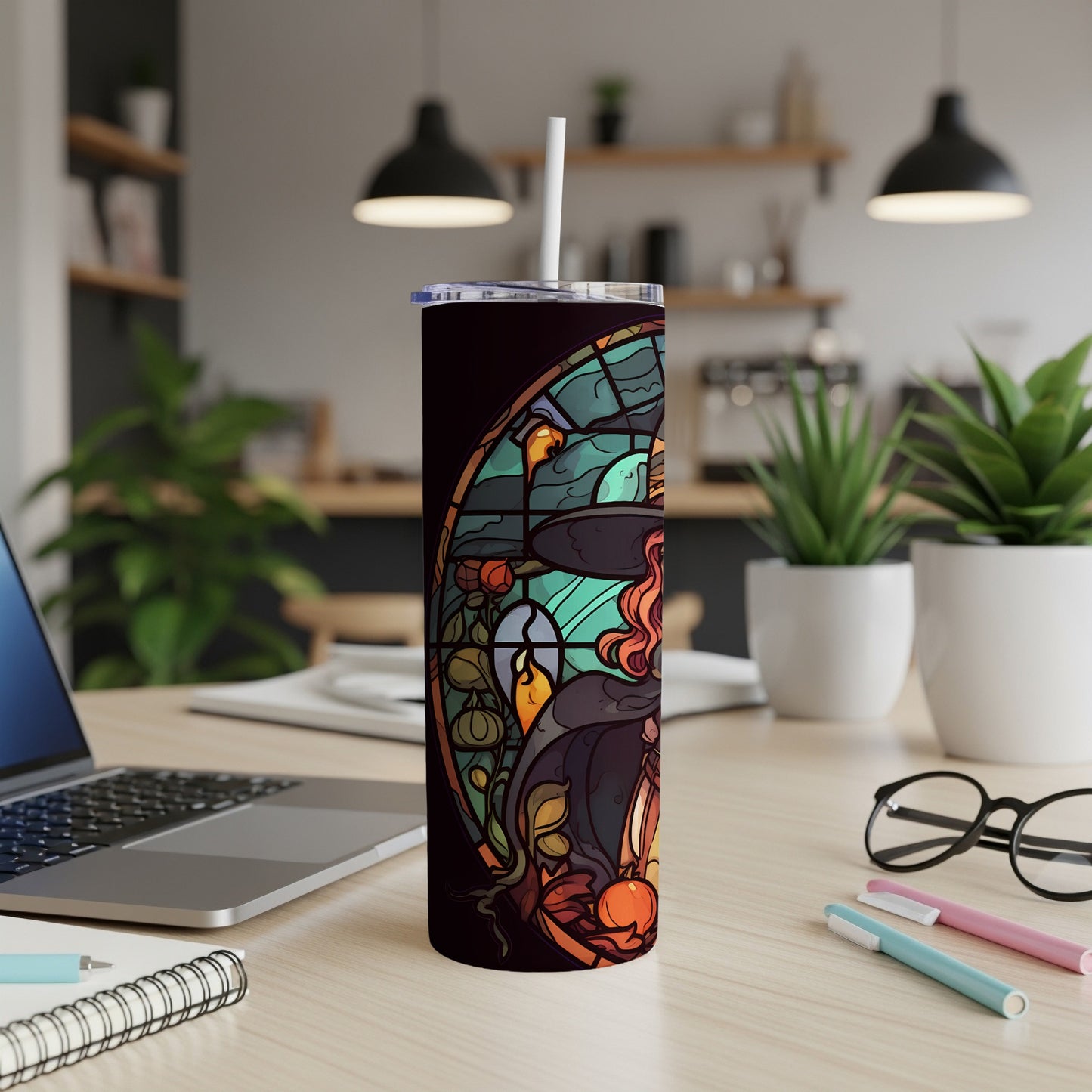 Stained glass witch with pumpkin and moon design on a black tumbler.