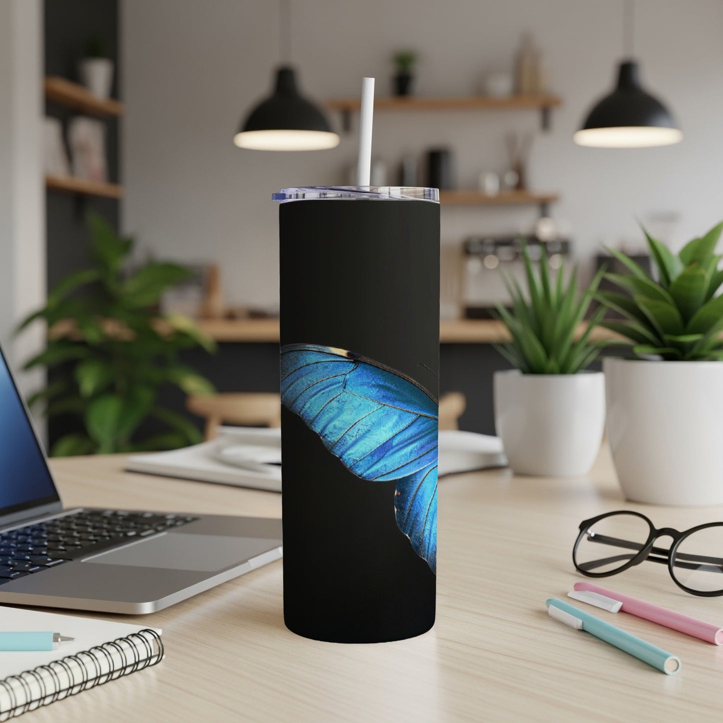 Black tumbler with a close-up blue butterfly wing design.