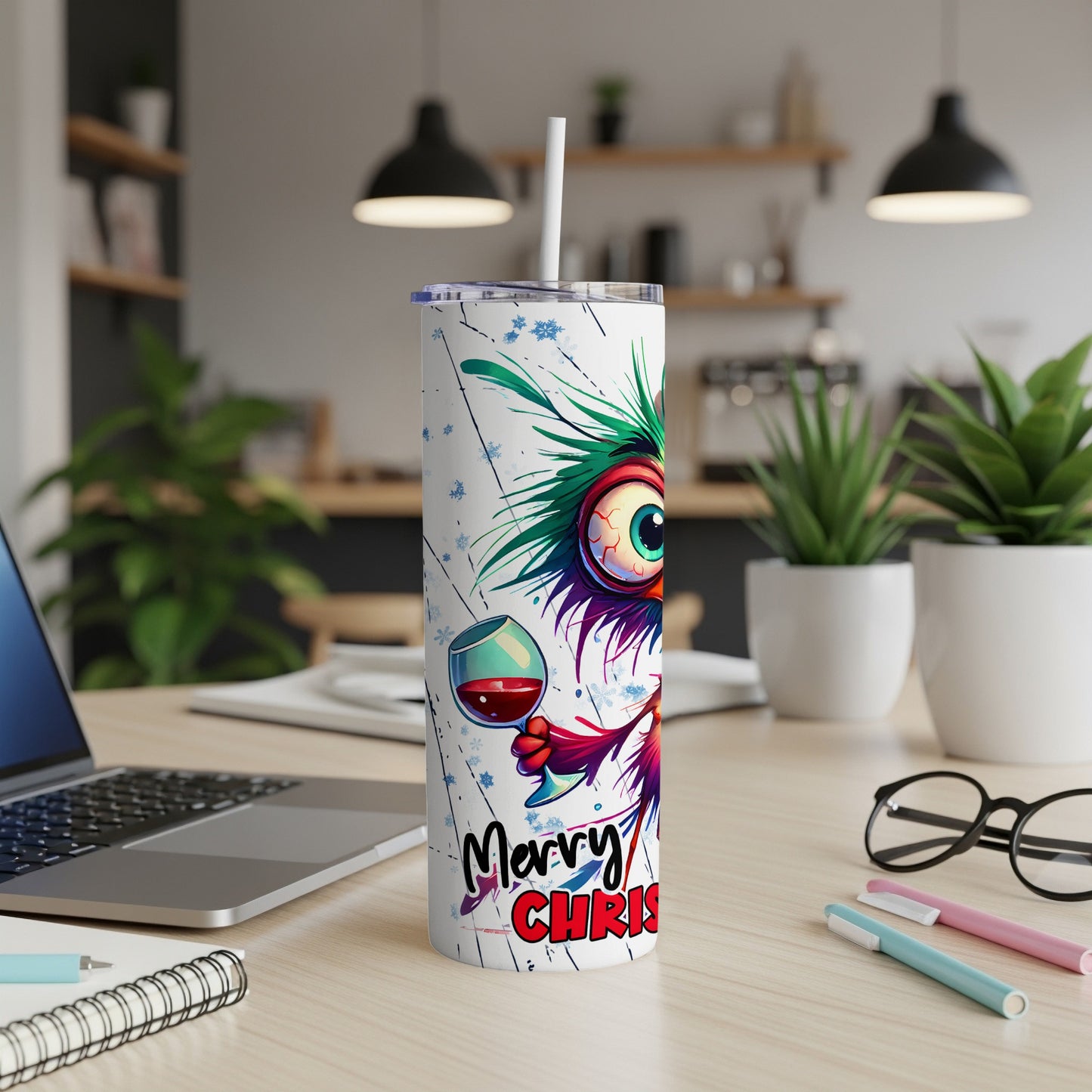 White tumbler with cartoon monster and "Merry Christ" text.