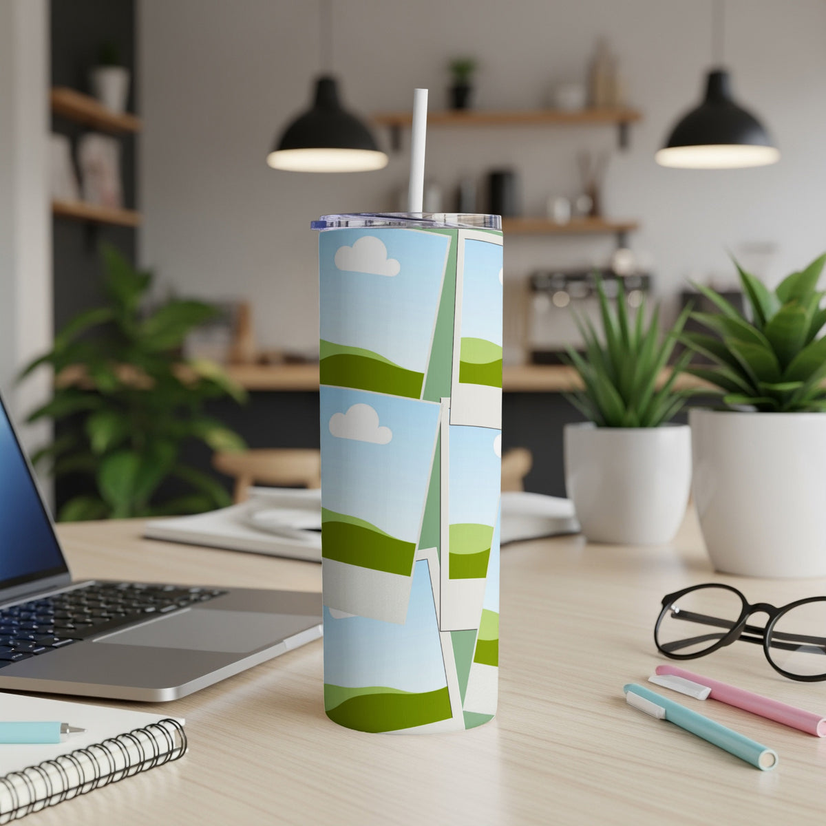 Tumbler with collage of landscape photos and clouds, with a straw.