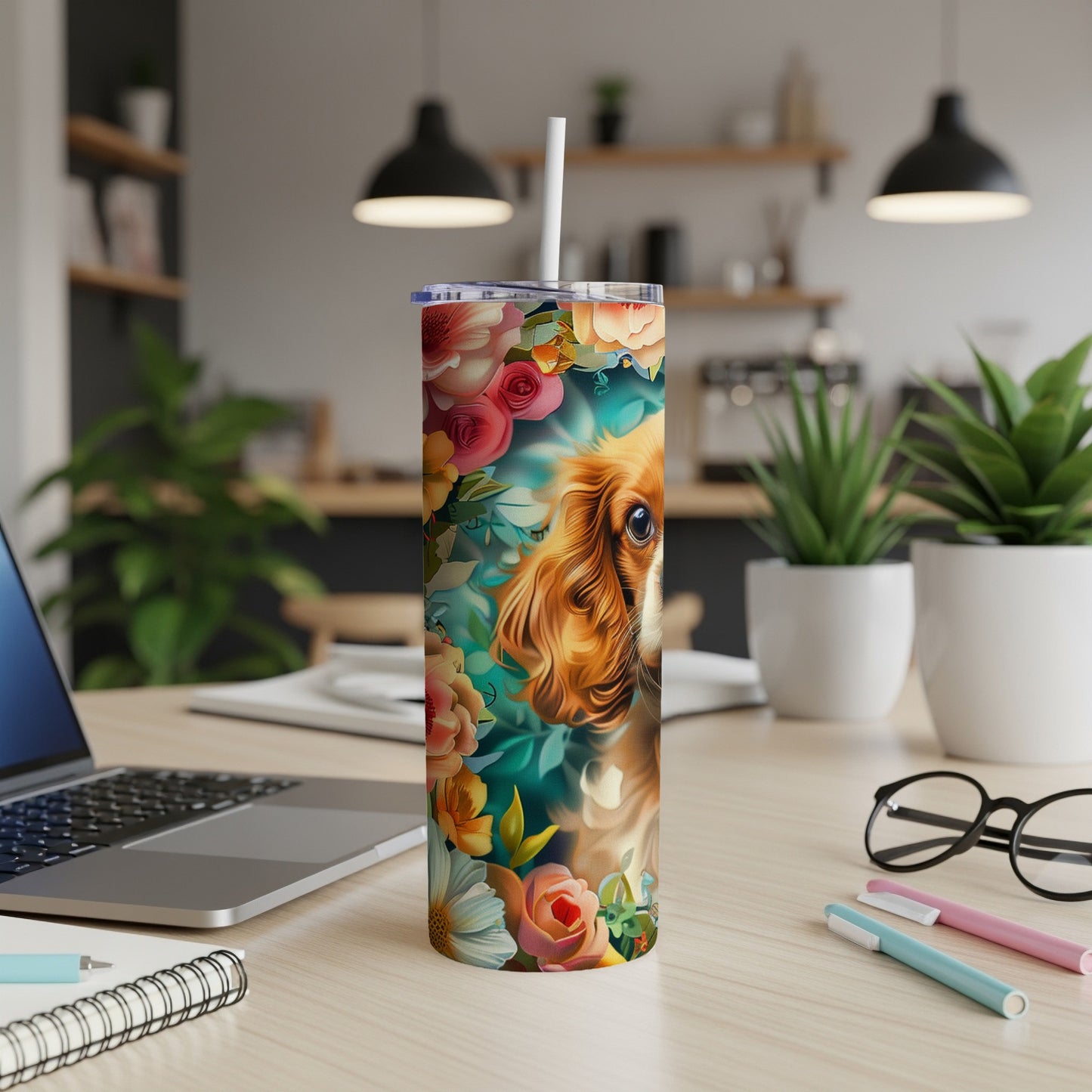 Cavalier King Charles Spaniel surrounded by colorful flowers on a patterned tumbler.