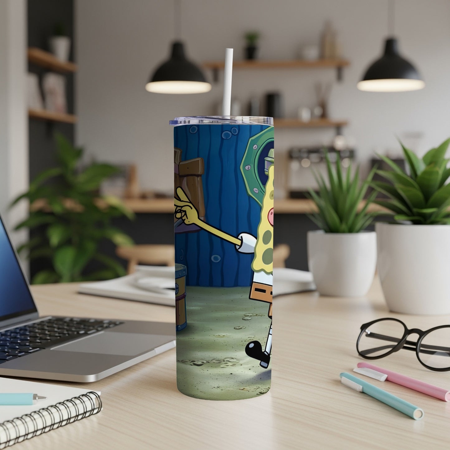 SpongeBob SquarePants character on a teal blue tumbler with a straw.