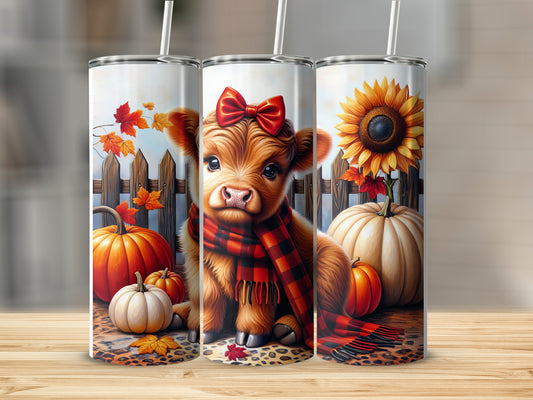 Cow with pumpkin and sunflower on wooden table.