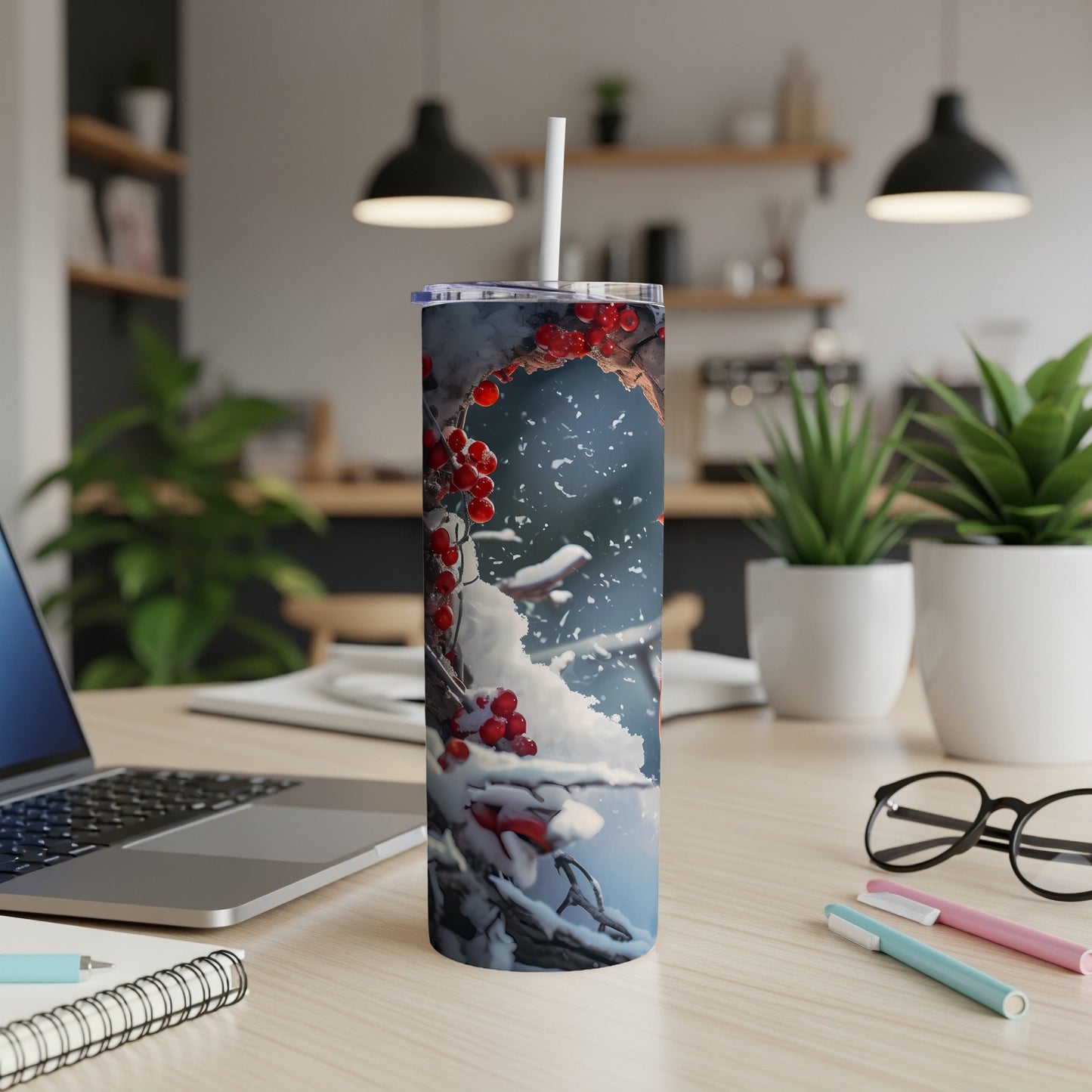 Snowy berries on a tumbler with a straw, on a desk.