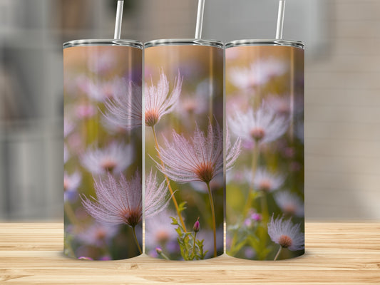 Three tumblers with dandelion seed head pattern on a wooden surface.