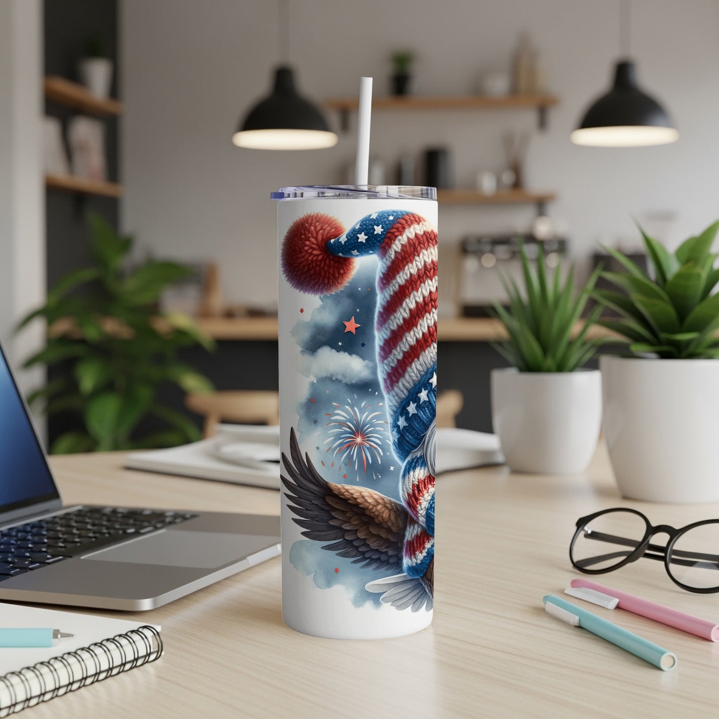 Patriotic tumbler with eagle and fireworks design, featuring a straw.