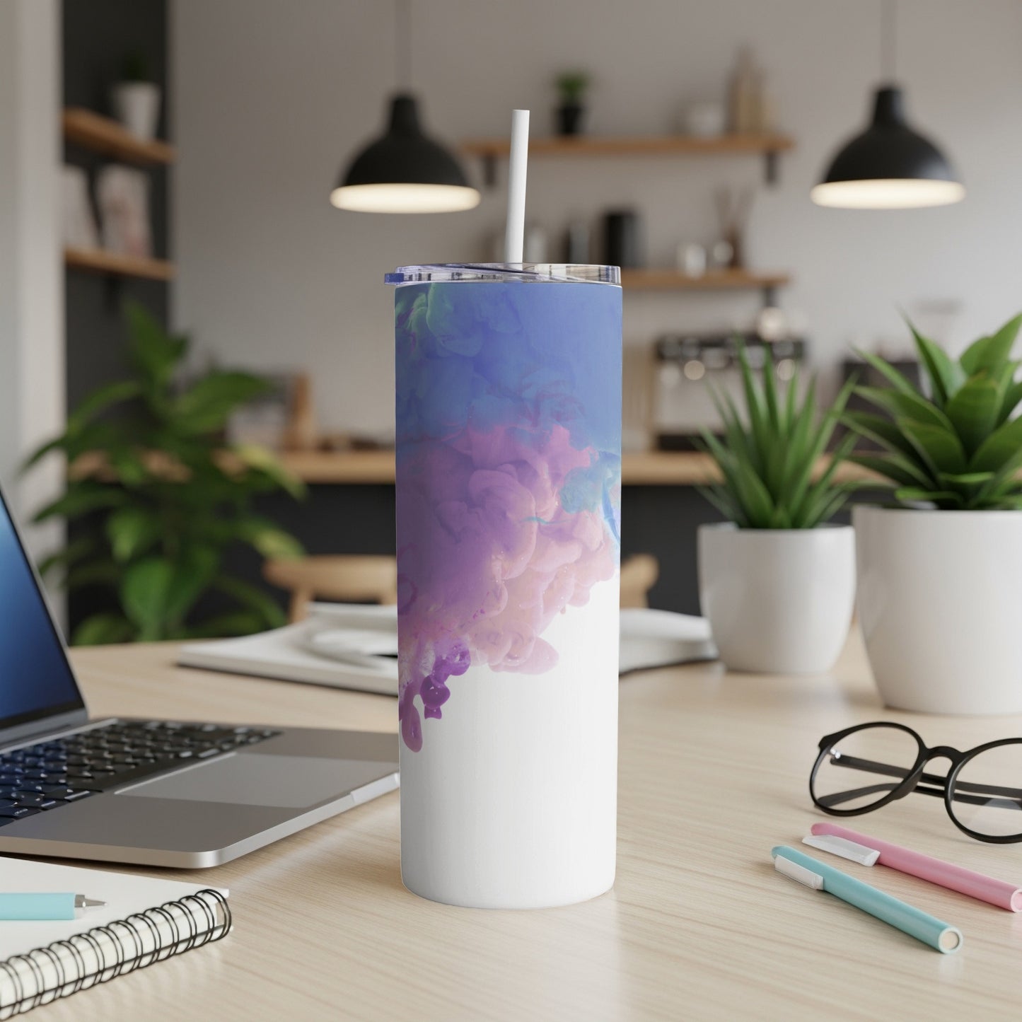 White tumbler with purple and blue abstract cloud design.