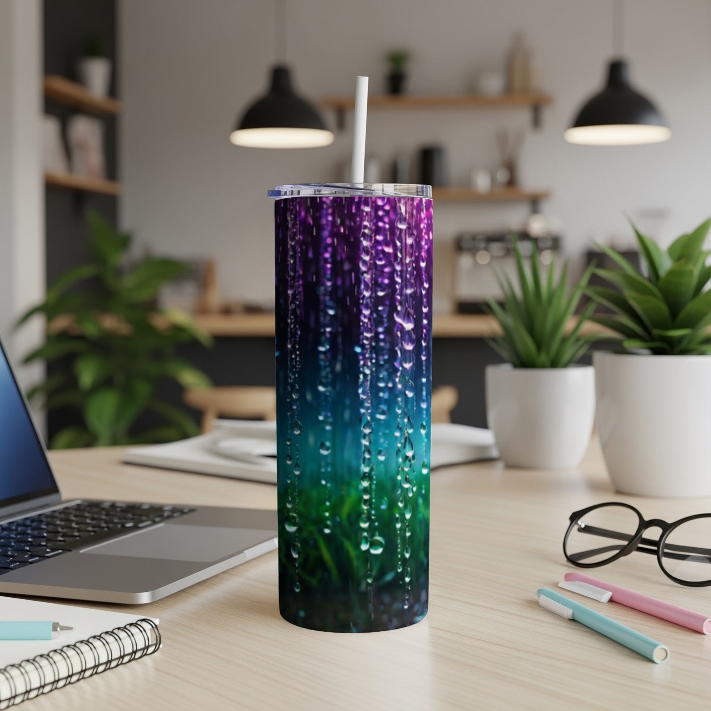 Tumbler with purple, blue, and green water droplet design.