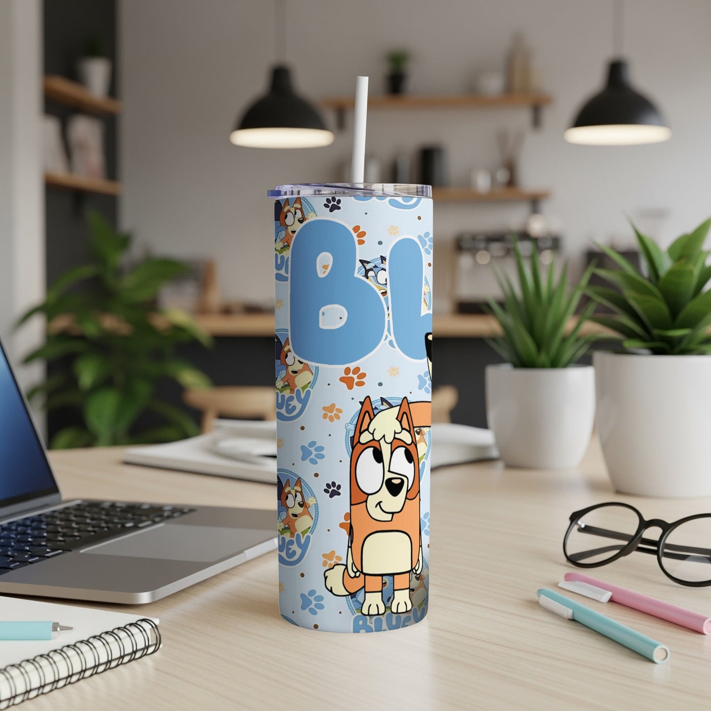 Bluey character tumbler with paw print and bone pattern.