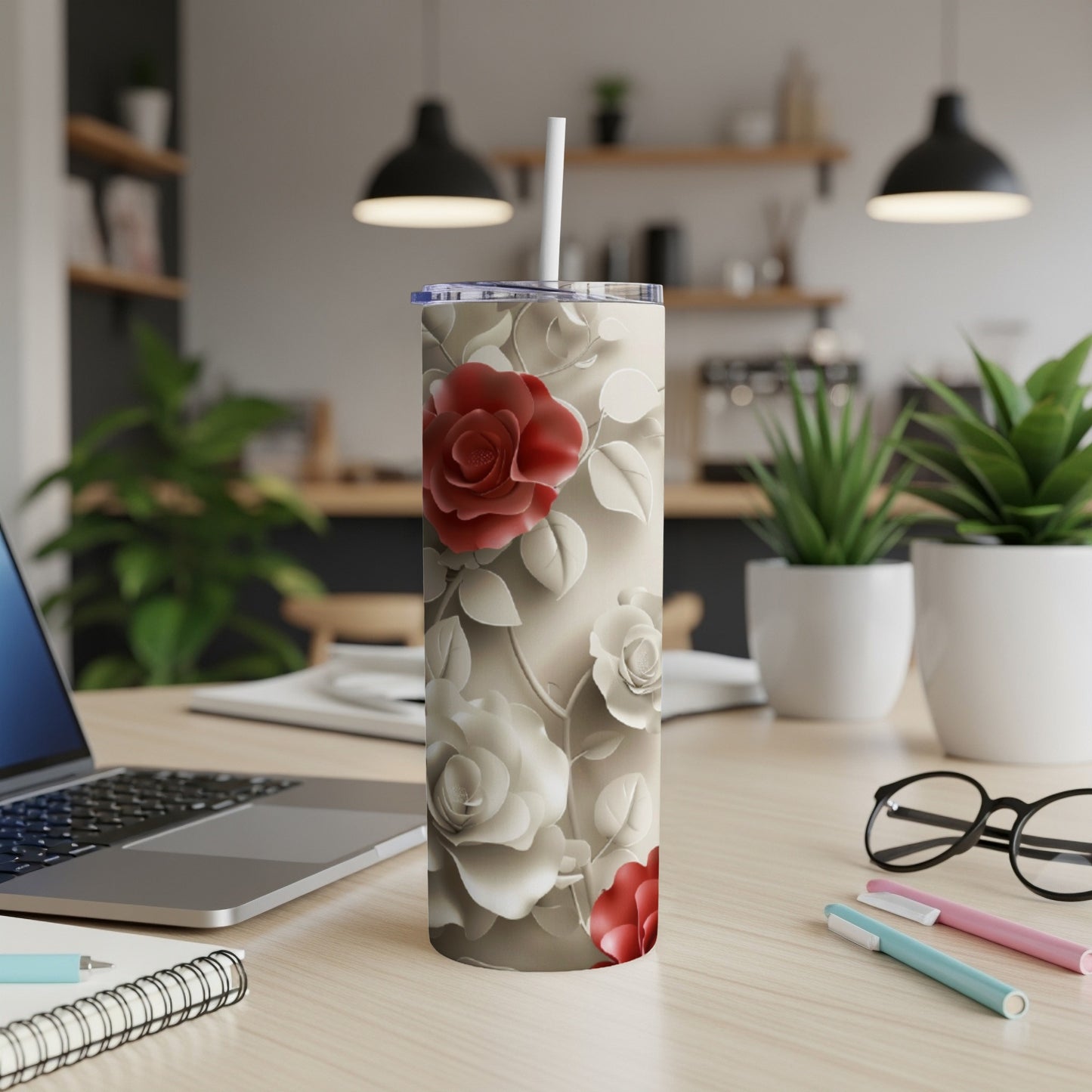 White tumbler with red roses and beige floral pattern, straw inserted.