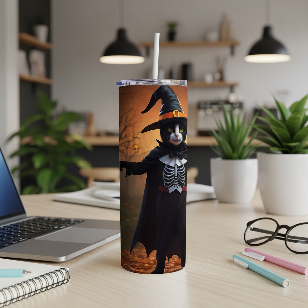 Black cat wearing witch hat and skeleton costume on a Halloween tumbler.