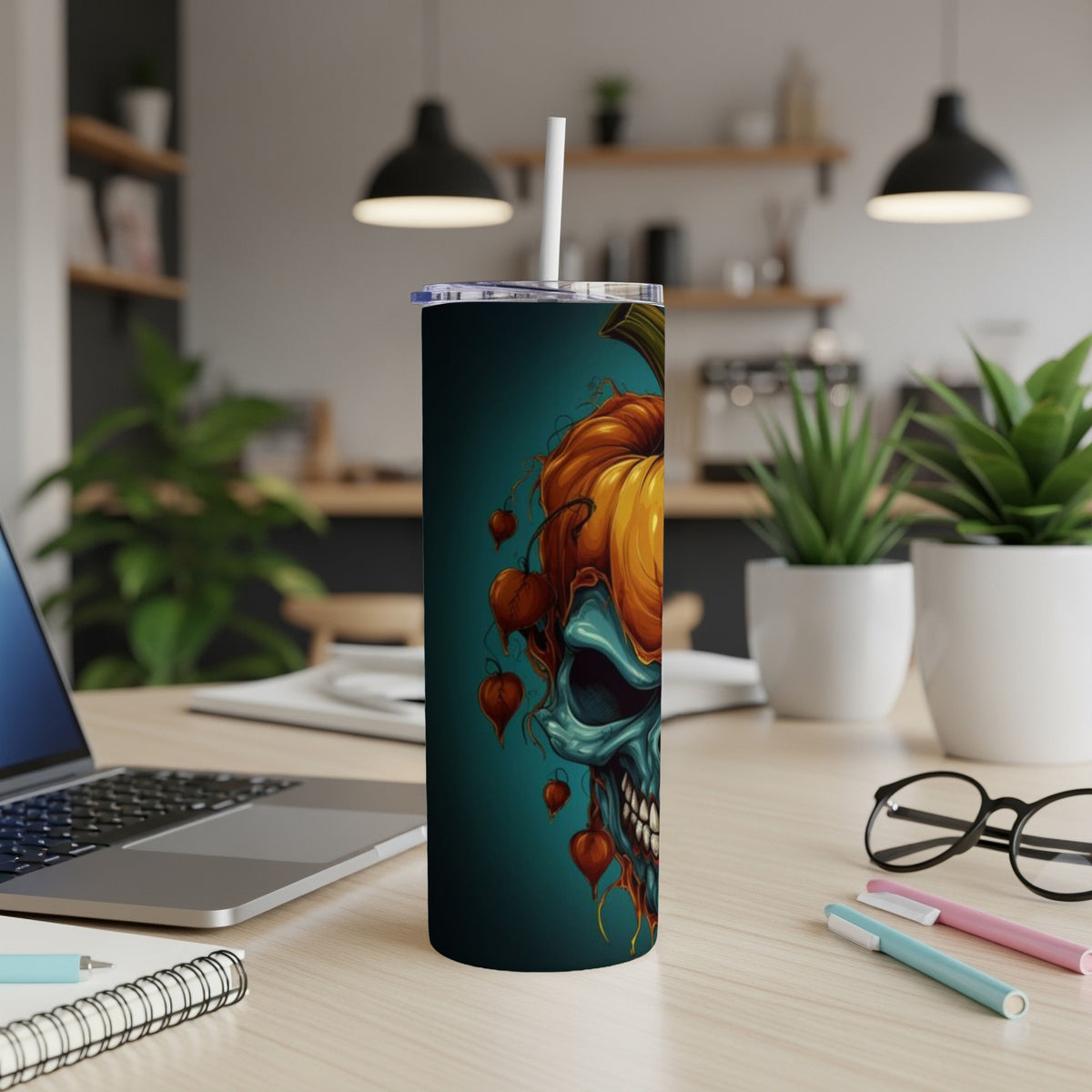 Tumbler with Halloween skull and pumpkin design, featuring teal and orange colors.