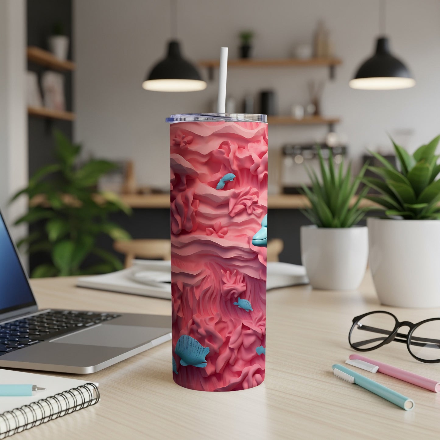 Pink textured tumbler with seashells and fish, with a straw.