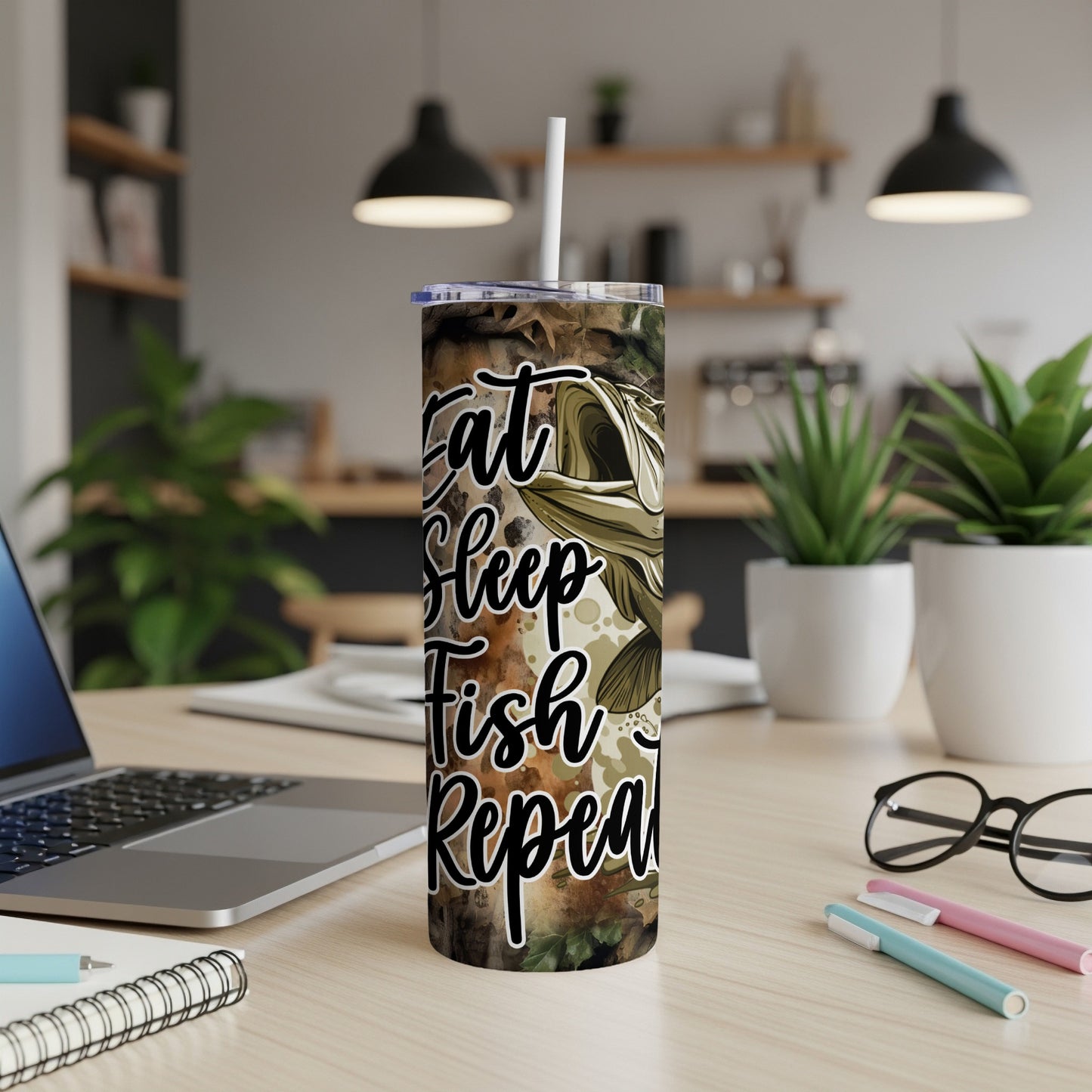 Camouflage tumbler with "Eat Sleep Fish Repeat" text and a fish graphic.