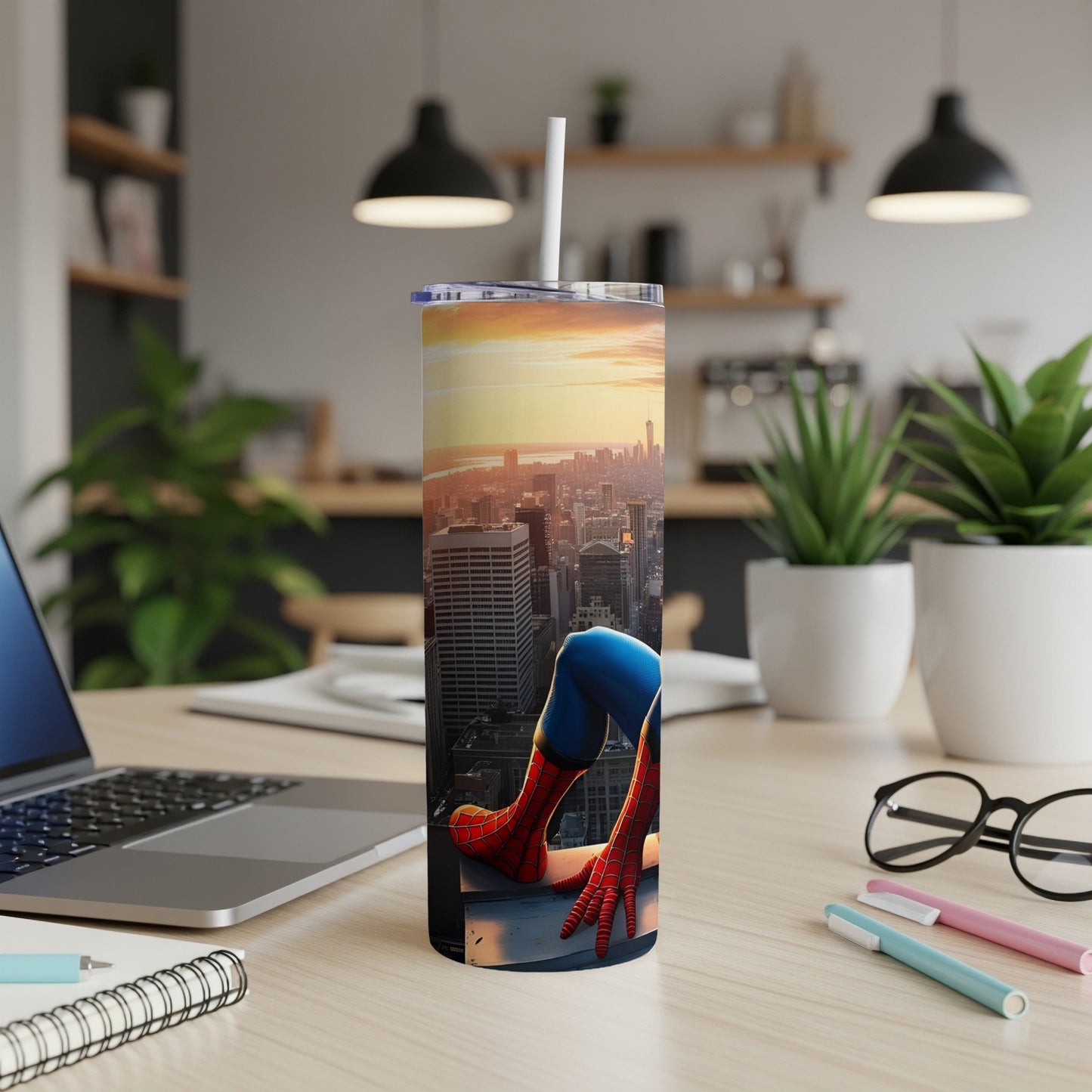 Spiderman perched on a city skyline on a tall tumbler with a straw.