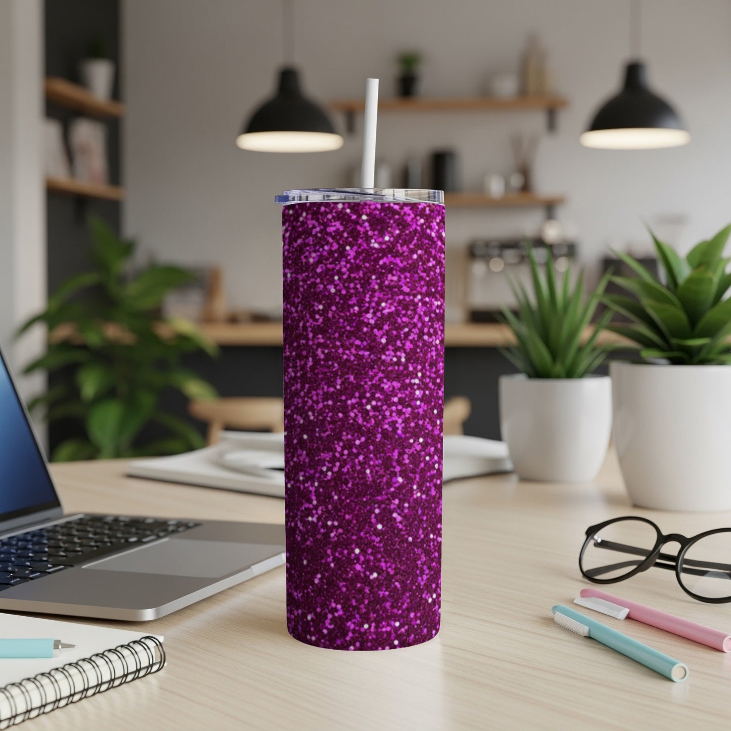 Purple glitter tumbler with white straw on desk.