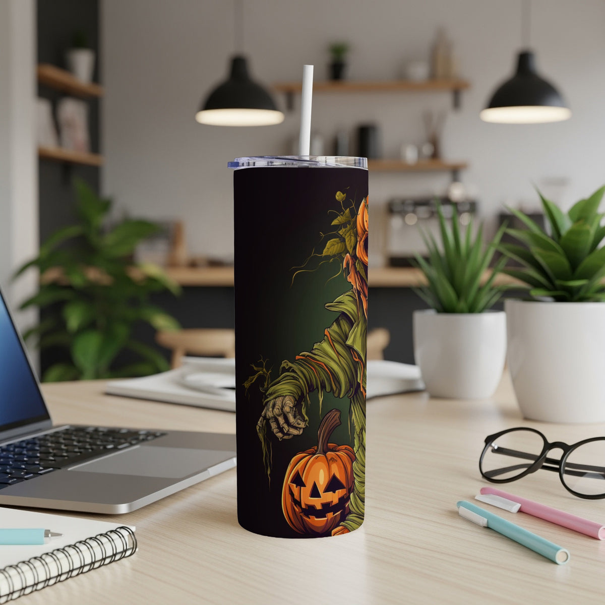 Black tumbler with a scarecrow and jack-o'-lantern Halloween design.