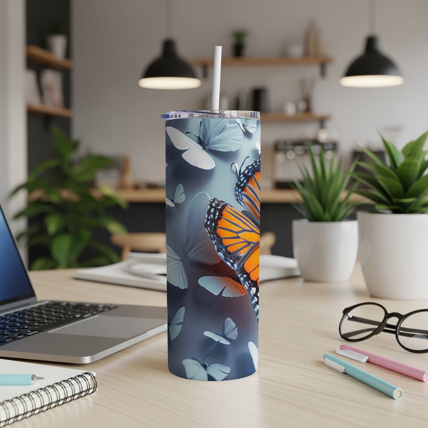 Monarch butterflies on a blue gradient tumbler with a straw.