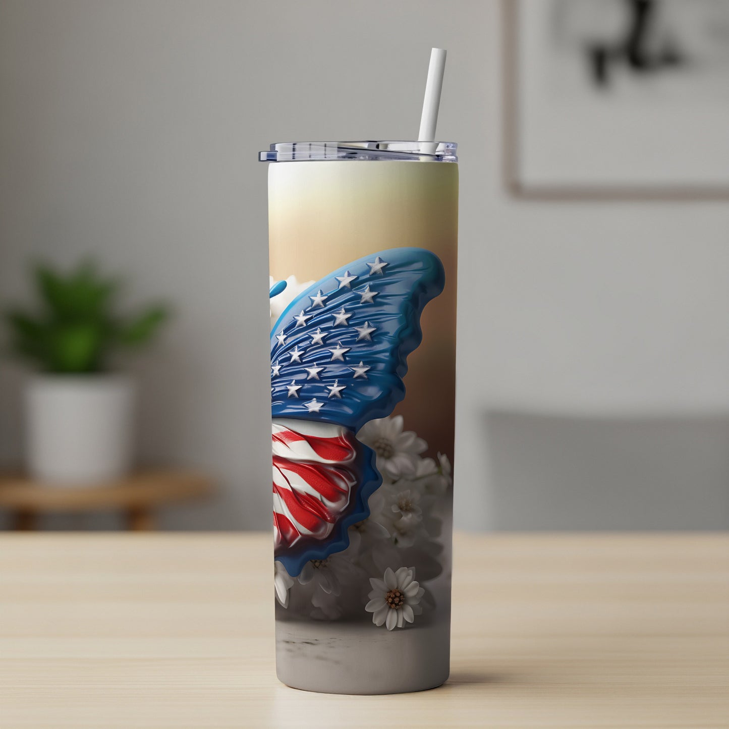 Tumbler with American flag butterfly wings and white flowers.