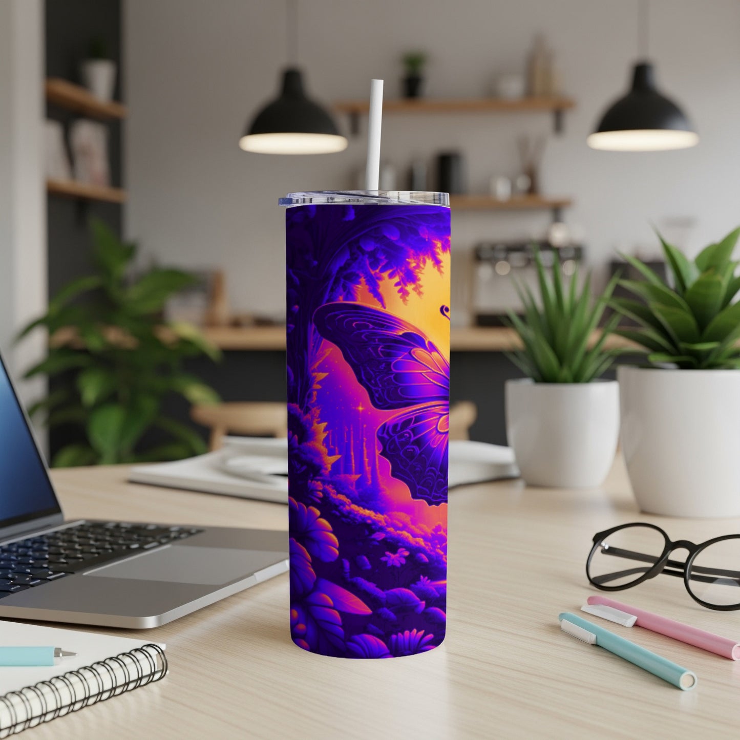 Purple and orange butterfly design on a tall, slender tumbler with a straw.