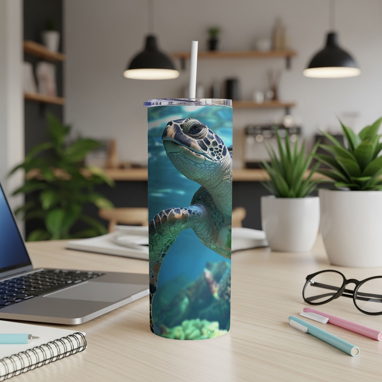 Sea turtle swimming underwater on a white stainless steel tumbler.