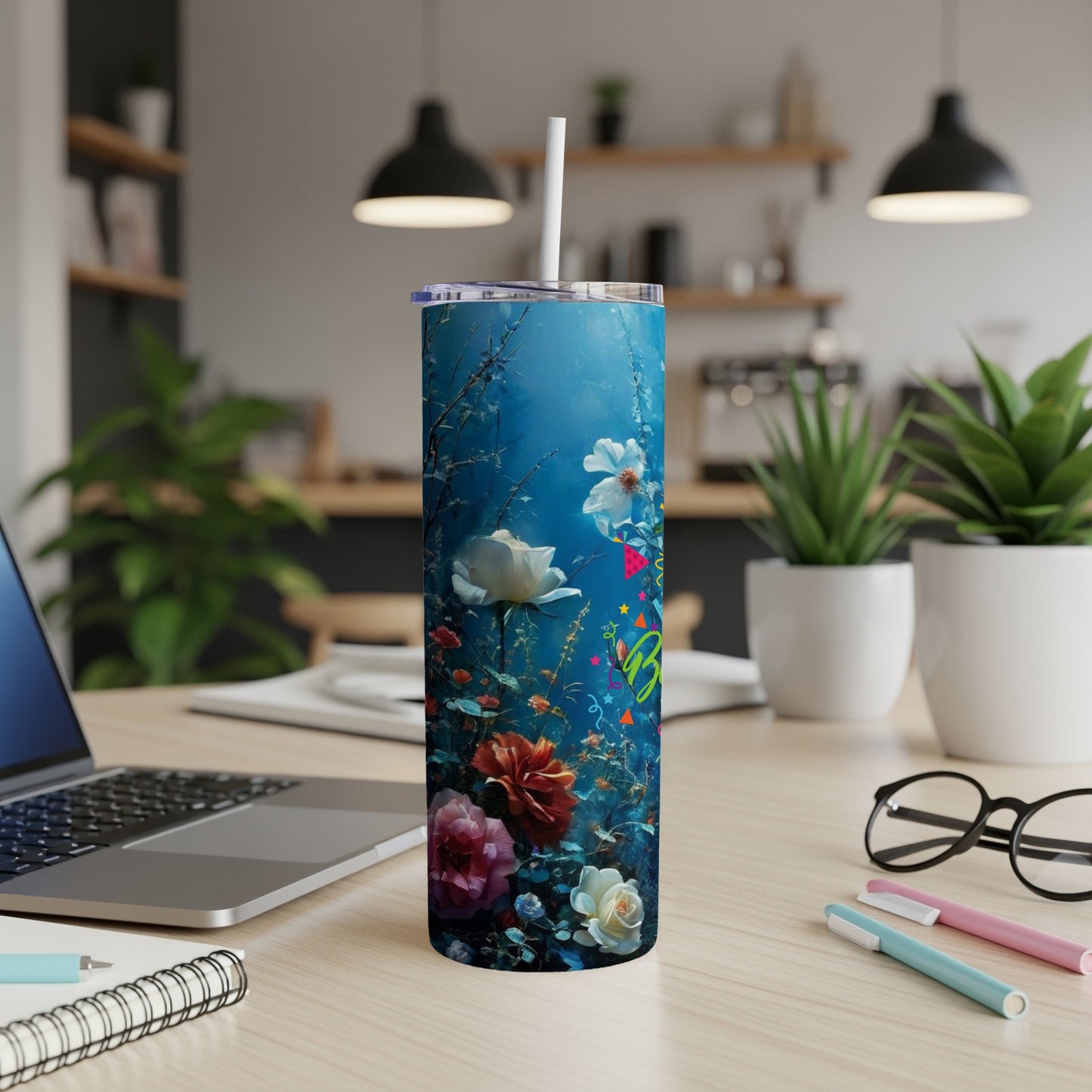 Floral and aquatic pattern on a white tumbler with a straw.