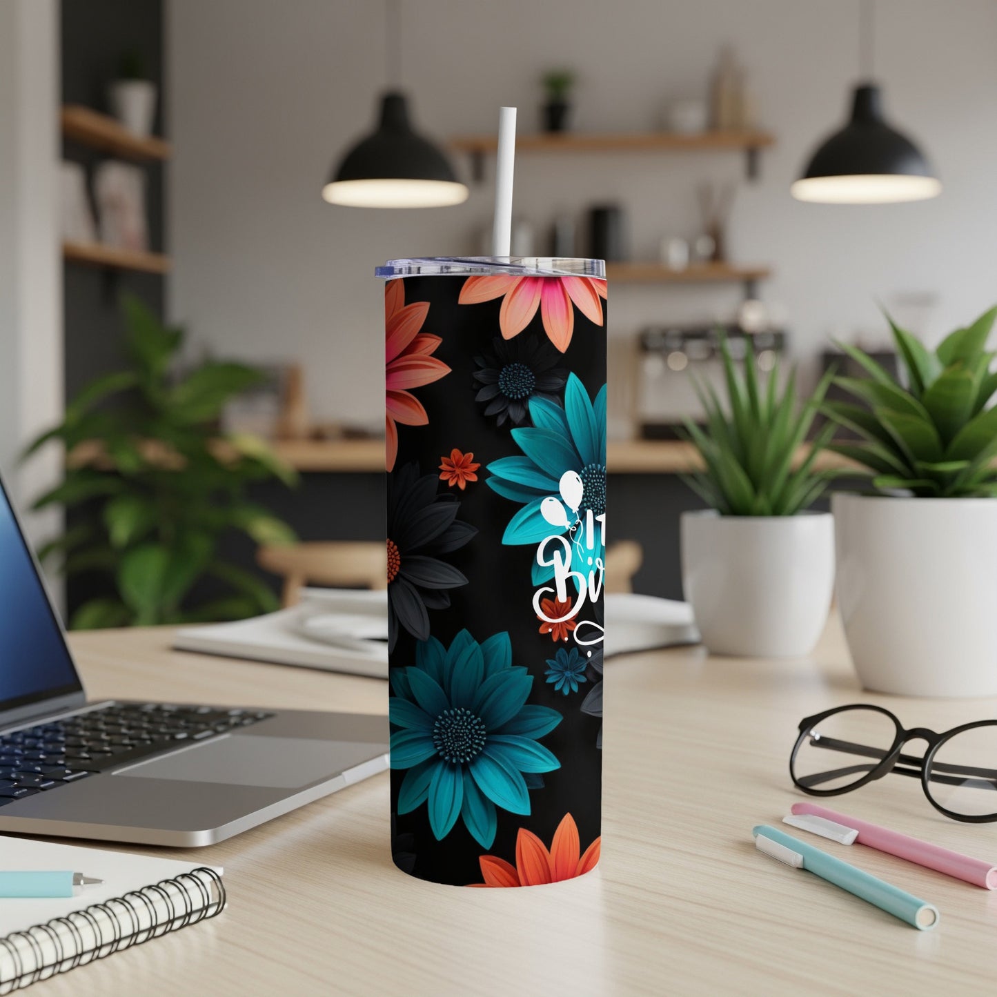 Black tumbler with teal and orange floral pattern and white "Blessed" text.
