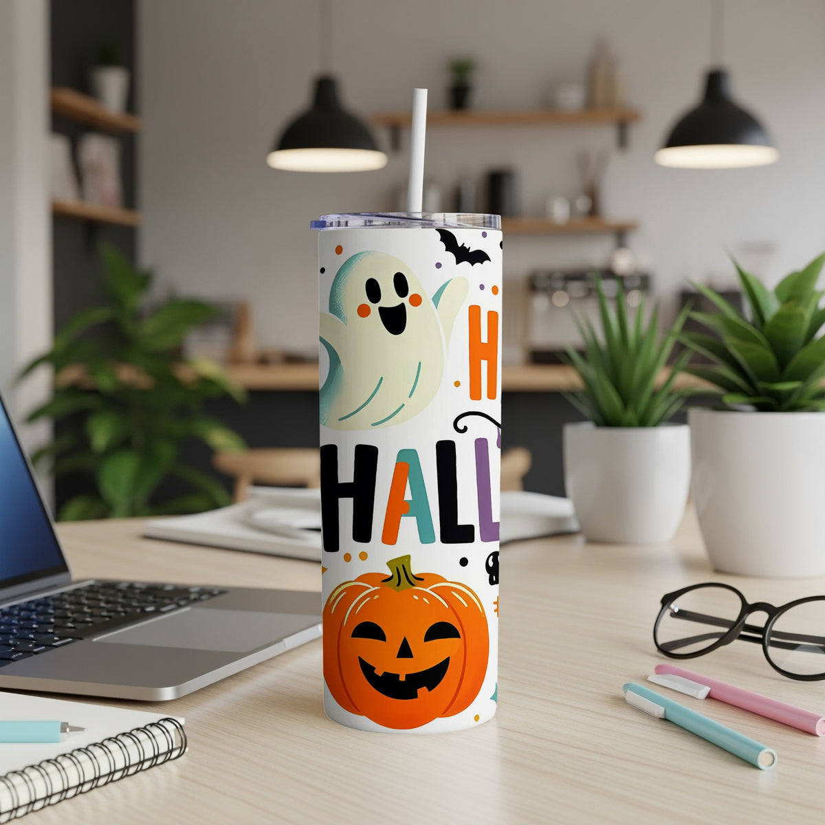 White tumbler with ghost, pumpkin, bat, and "Halloween" text design.