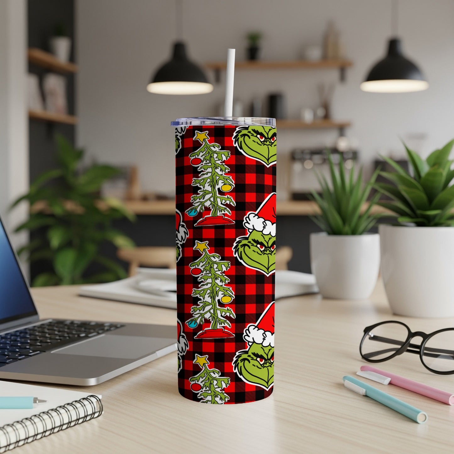 Grinch Christmas tree pattern tumbler with red buffalo plaid background.
