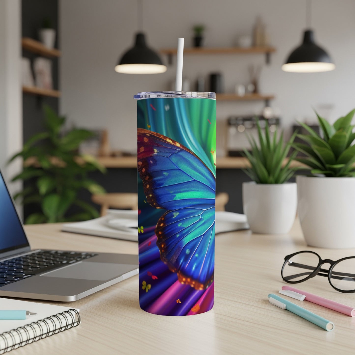 Blue butterfly wings and vibrant abstract background on a skinny tumbler.