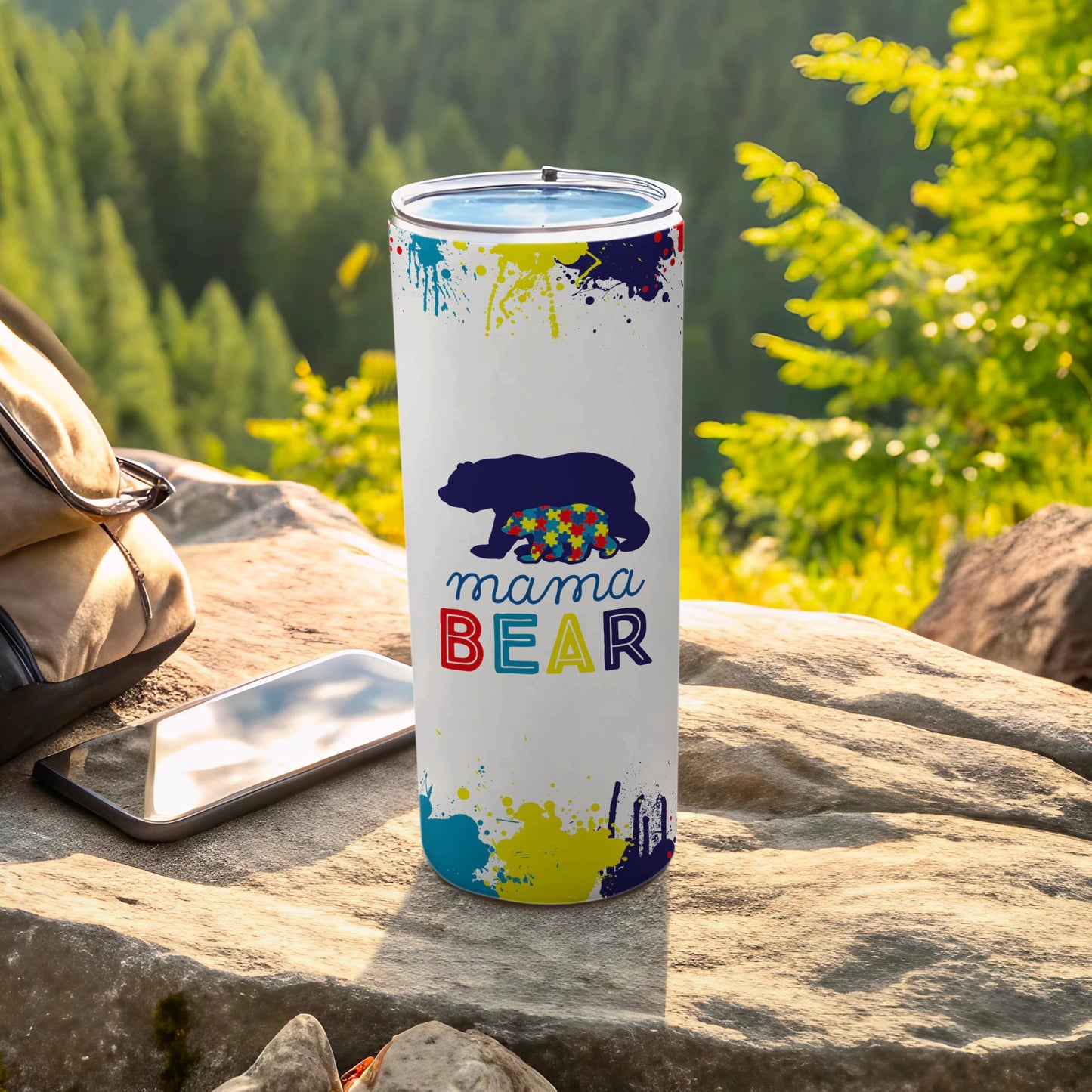 Mama Bear tumbler with colorful paint splatters and autism puzzle piece design.