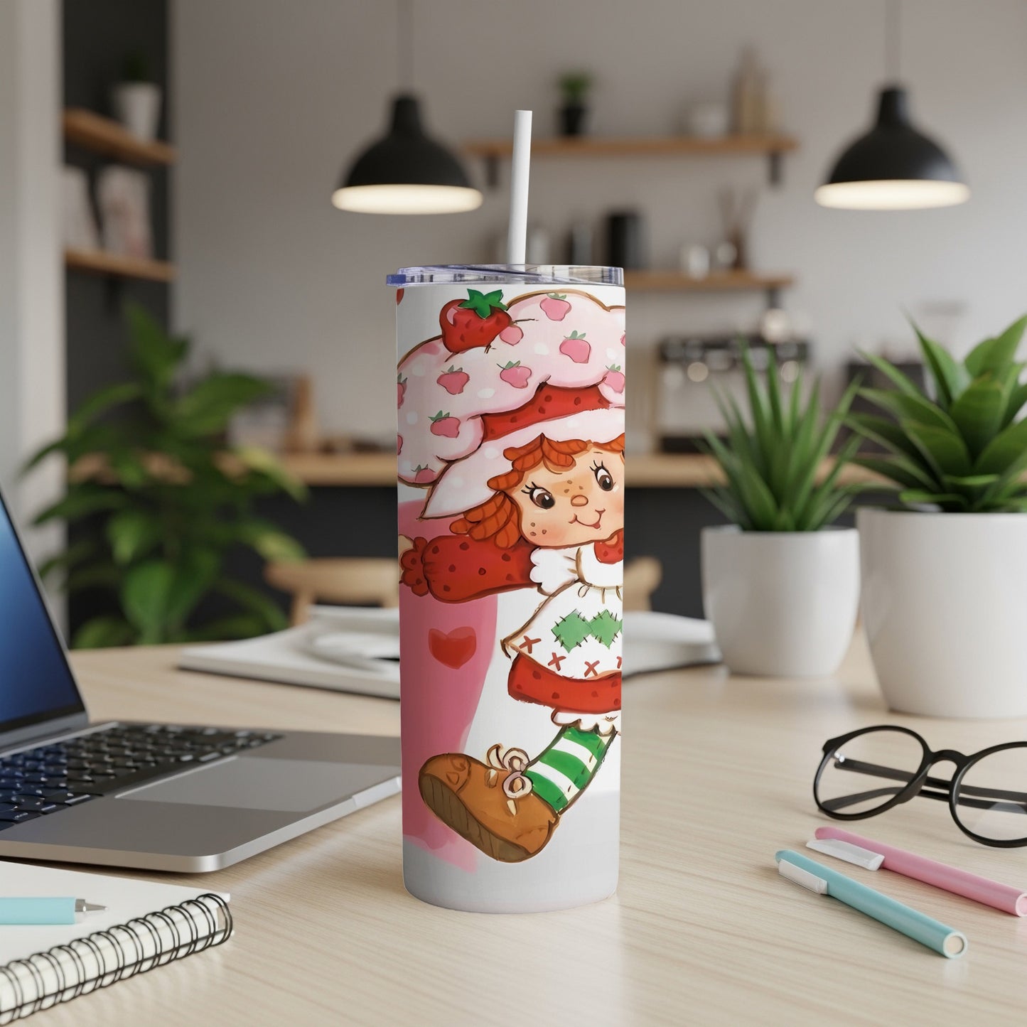 Strawberry Shortcake on a tall, white tumbler with a straw.