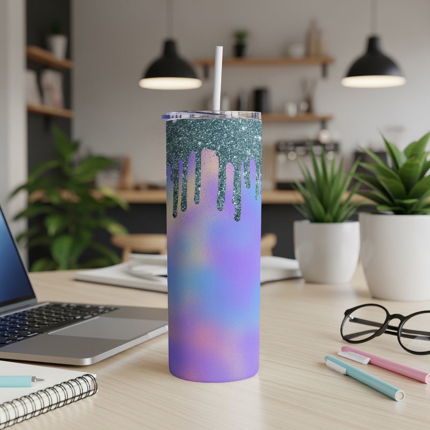 Tumbler with glitter drip design on pastel gradient and reusable straw.