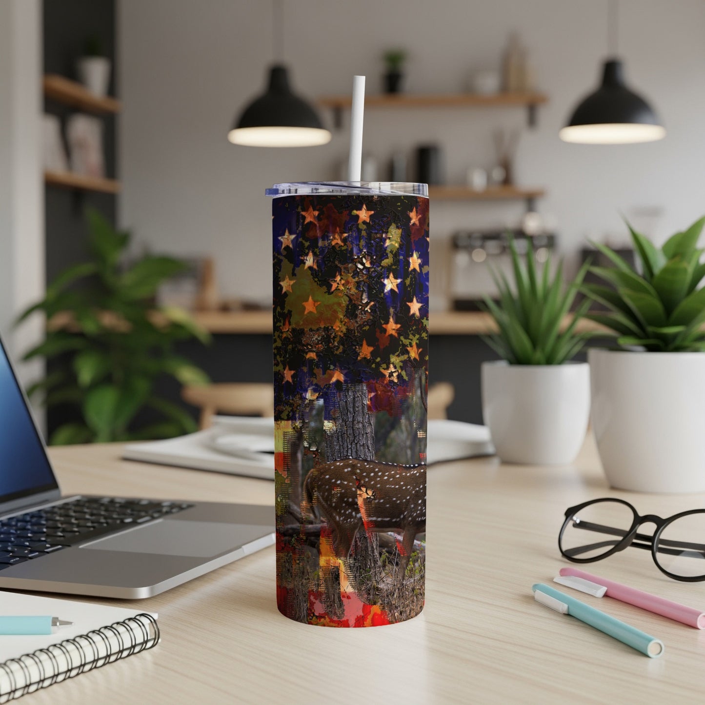 Tumbler with American flag, stars, and deer in a forest scene.