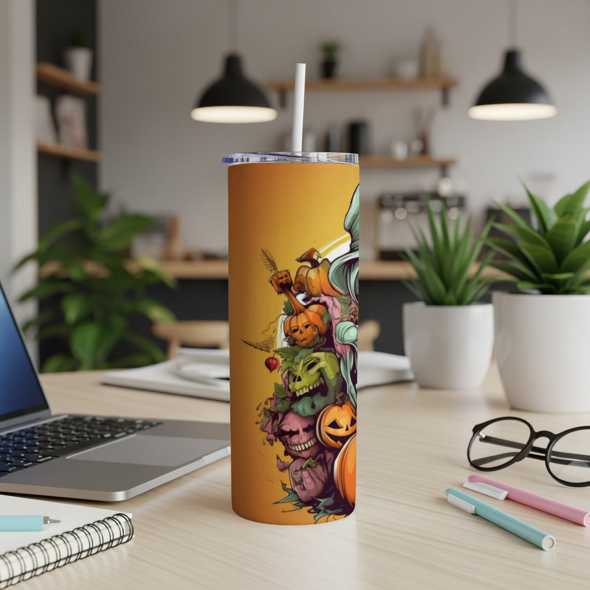 Orange tumbler with a Halloween monster, skull, and pumpkin graphic.