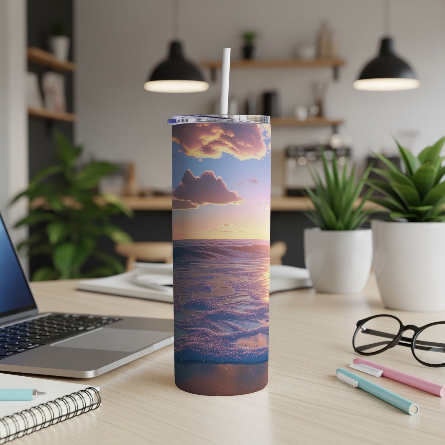 Tall tumbler with a sunset ocean wave design and straw.
