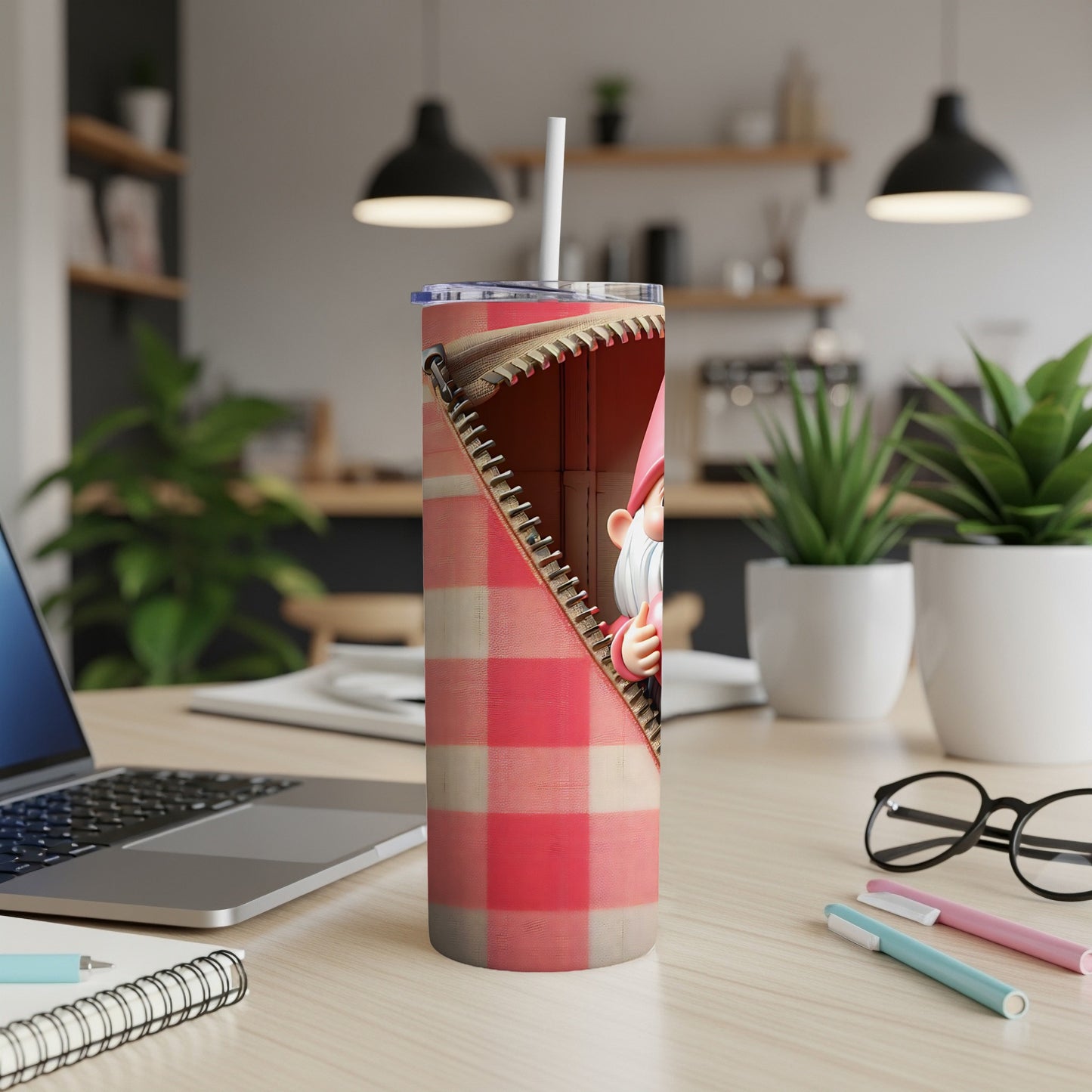 Gnome peeking through a red and white plaid zipper on a tumbler.