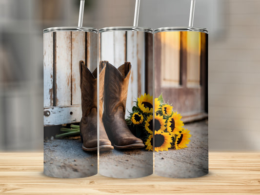 Three rustic cowboy boots and sunflowers against a weathered wooden backdrop.