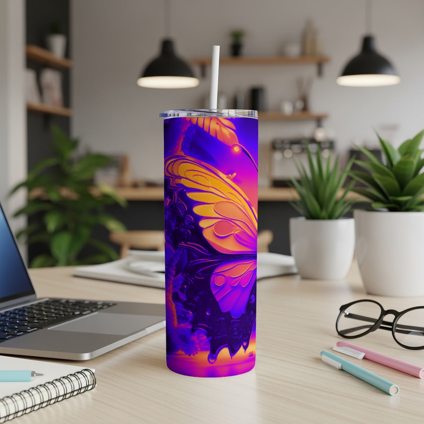 Purple and orange butterfly design on a skinny tumbler with a straw.