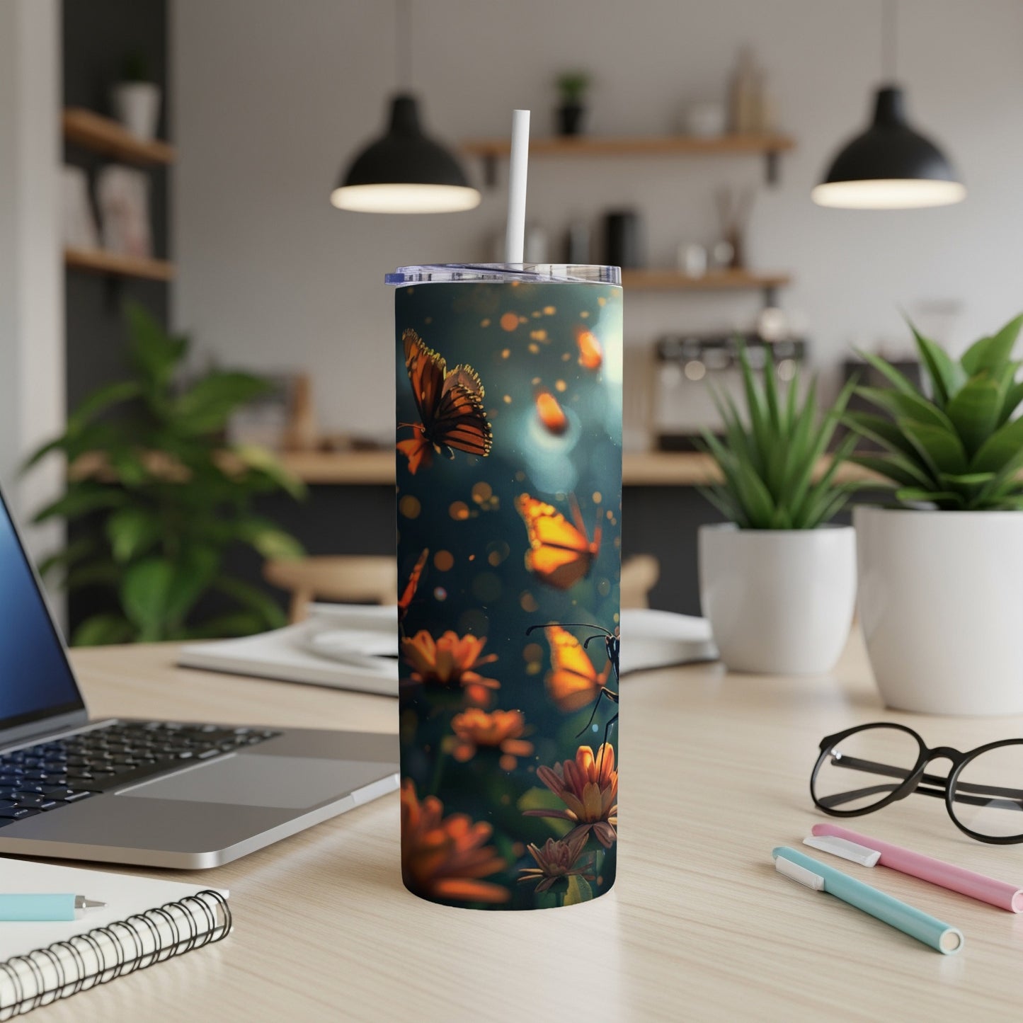 Tumbler with monarch butterflies and flowers, with a straw.