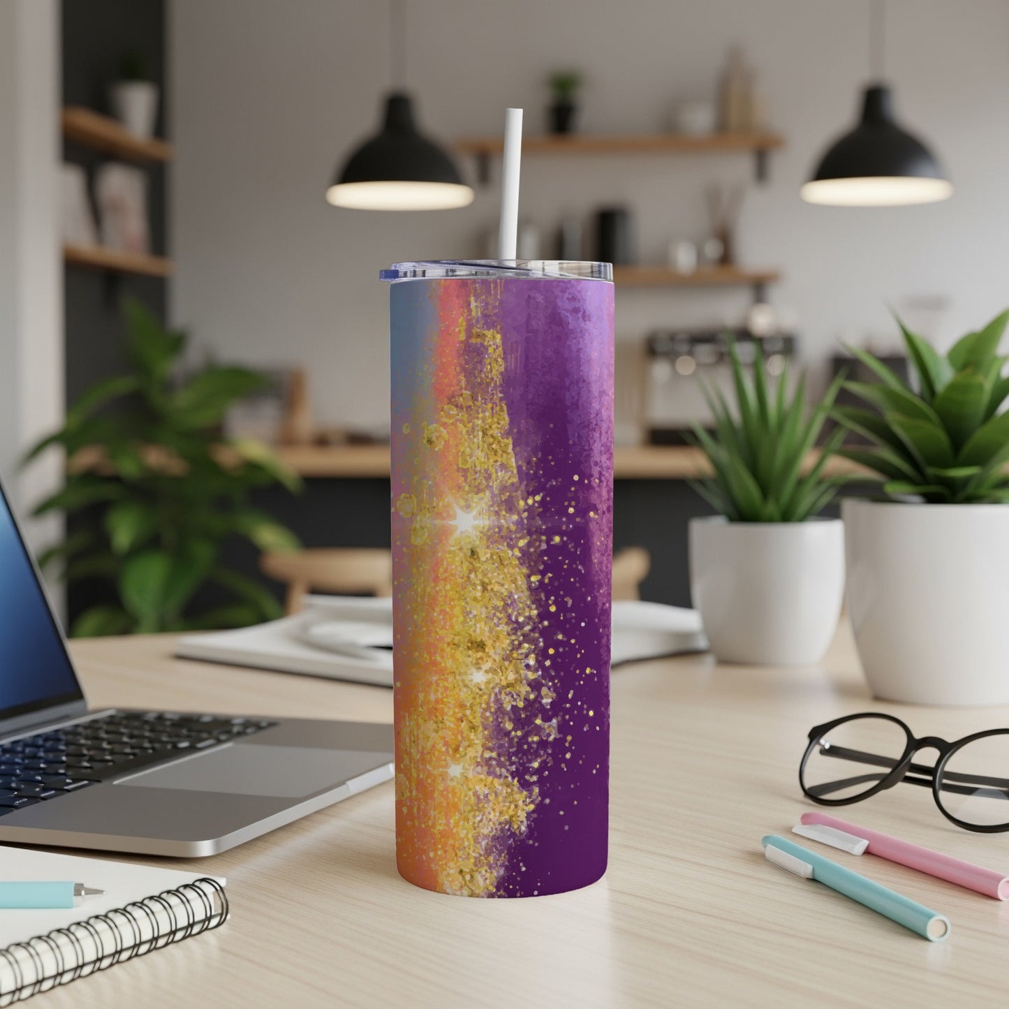 Tumbler with colorful abstract paint splash and gold glitter design.