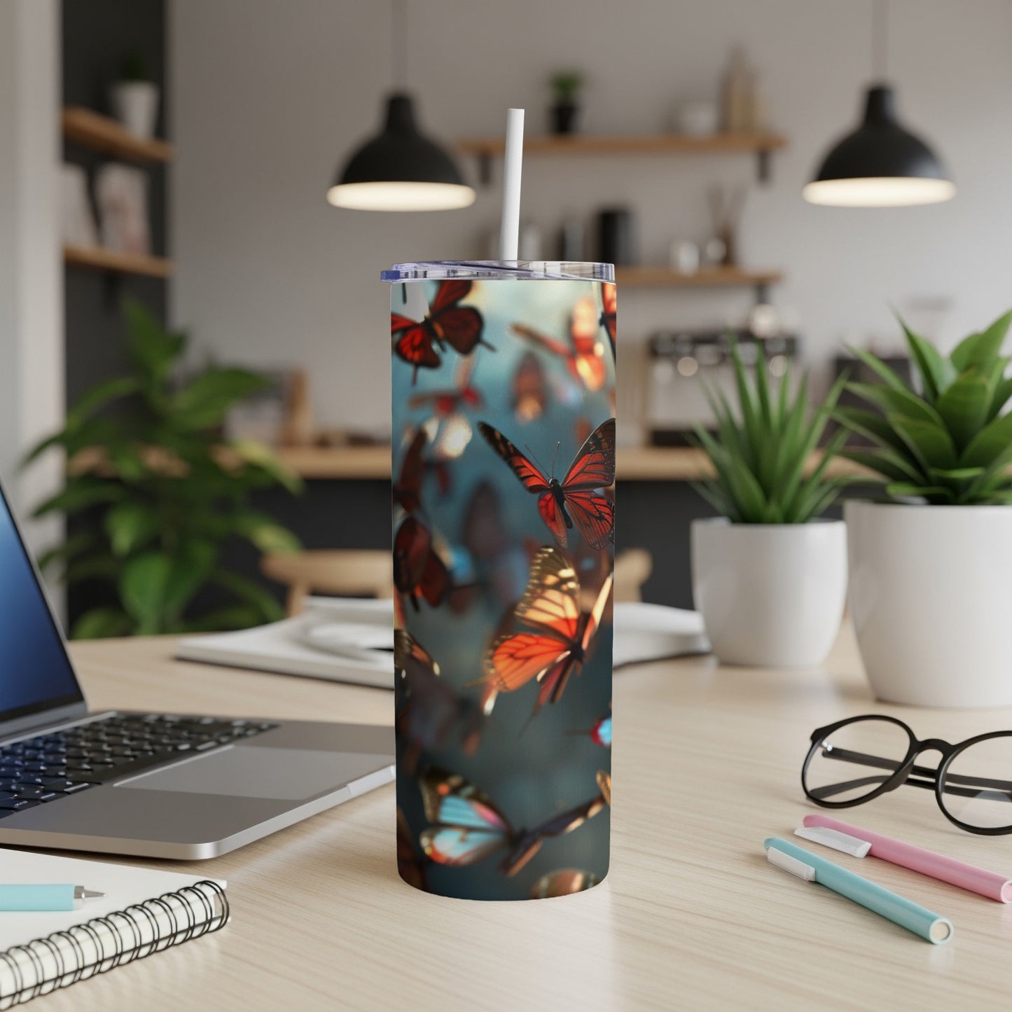 Tumbler with colorful butterflies in flight on a blurred background.