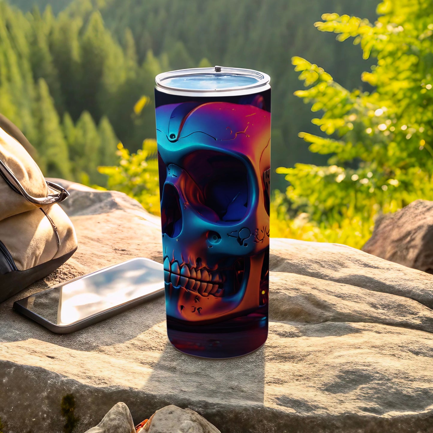 Tumbler with iridescent skull design on outdoor table.
