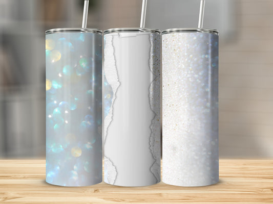 Three tumblers with glittery and ripped paper designs on a wooden surface.