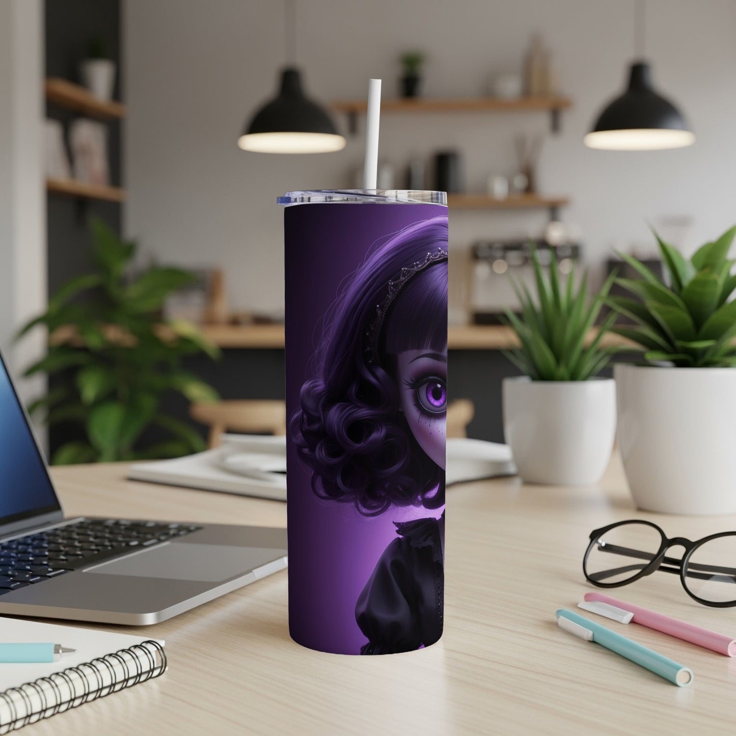 Purple gothic doll tumbler with straw on desk.
