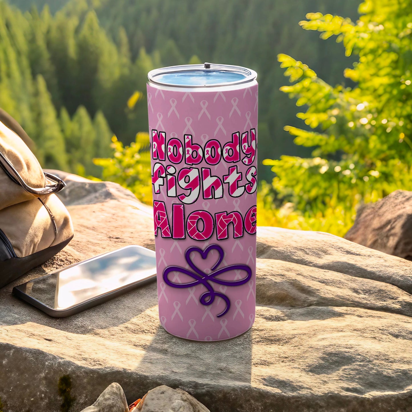 Pink tumbler with "Nobody Fights Alone" text and awareness ribbons.