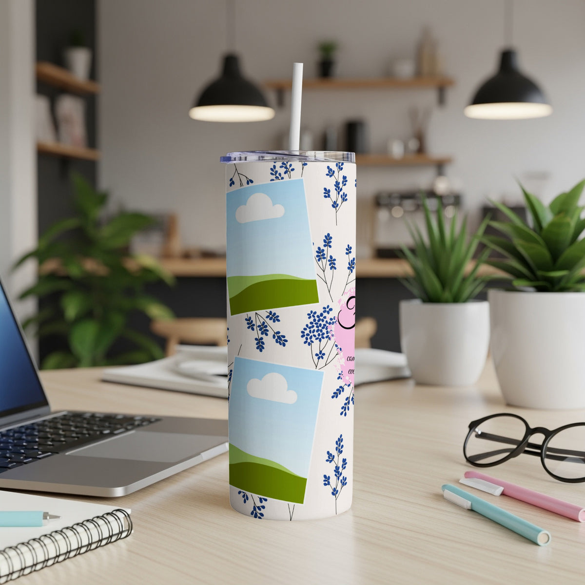 Tumbler with blue floral pattern and photo placeholders on a desk.