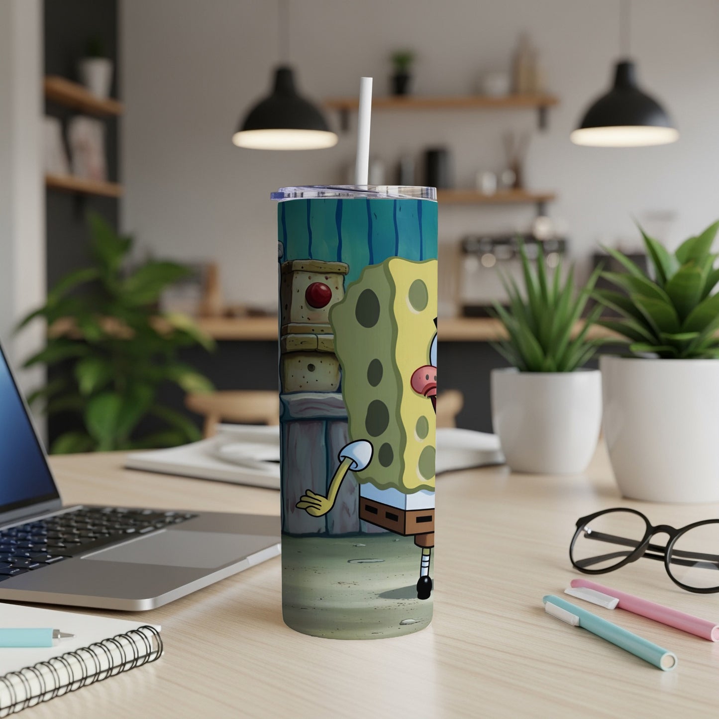 SpongeBob SquarePants character on a blue and green striped tumbler with straw.