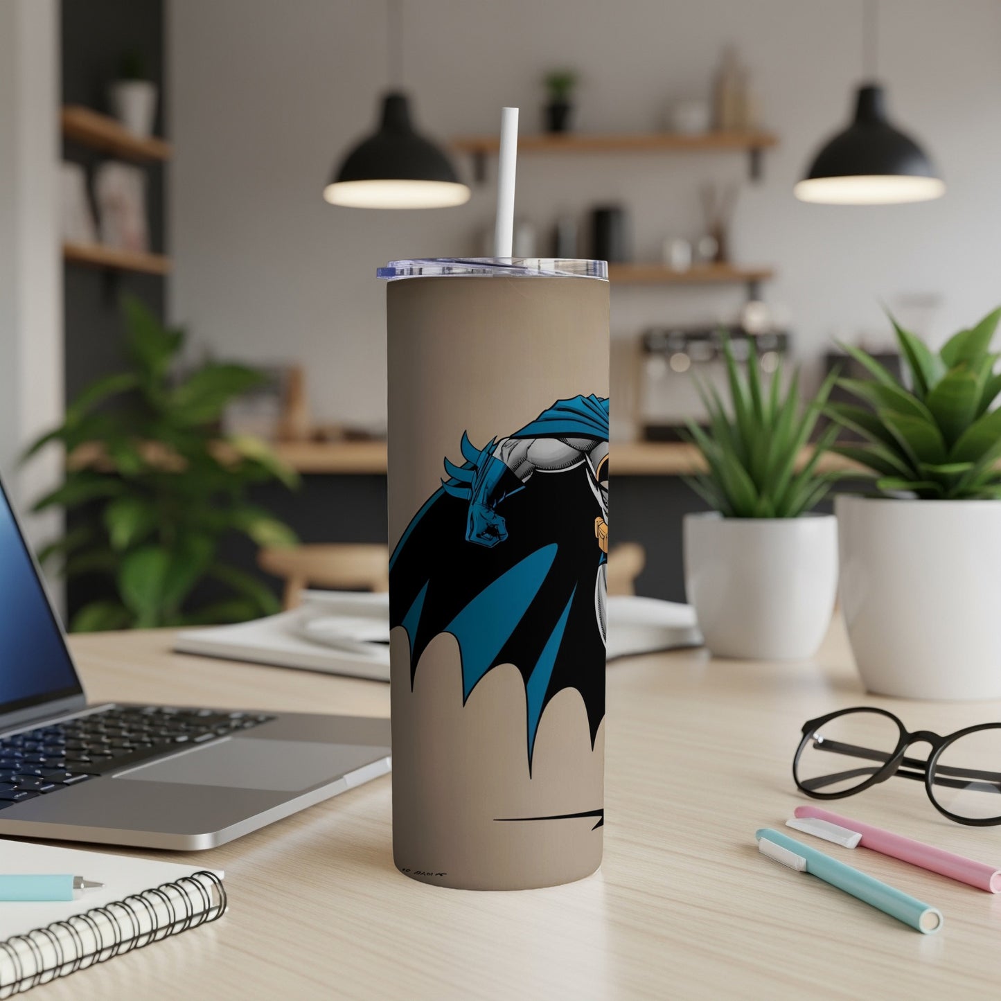 Batman illustration on a beige tumbler with a straw.